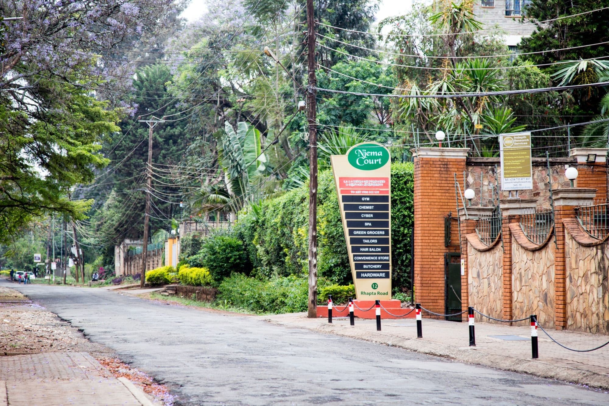 The Njema Court gate and signboard on leafy Rhapta Road